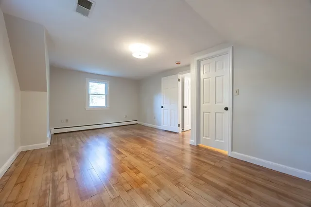 wooden floor in an empty room with window