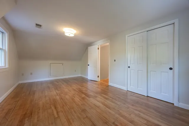 a view of an empty room and wooden floor