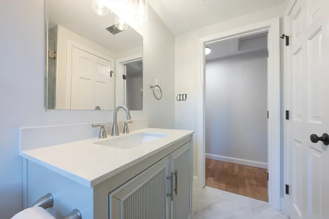 a bathroom with a sink a mirror and a vanity