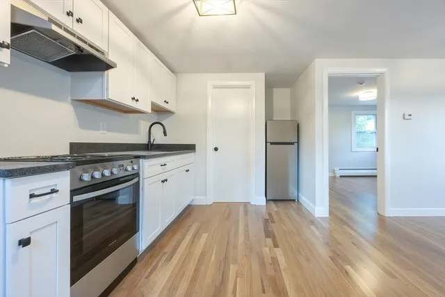 a kitchen with a stove oven and sink