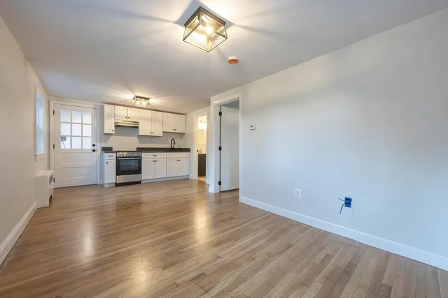 a view of a kitchen with a stove cabinets and wooden floor