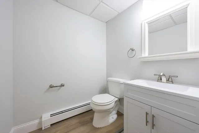 a bathroom with a sink a toilet and a mirror