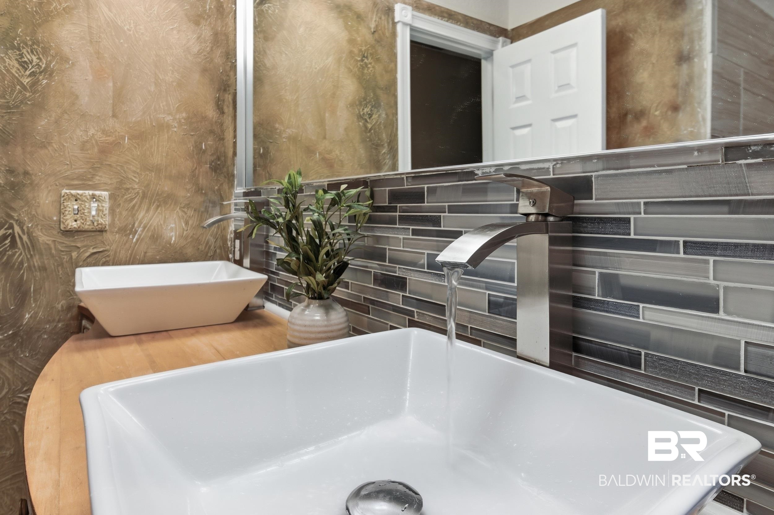 51620 Robert White Road Bay Minette, AL 36507 - Photo 49 of 81 Modern vessel sink with a brushed nickel waterfall faucet