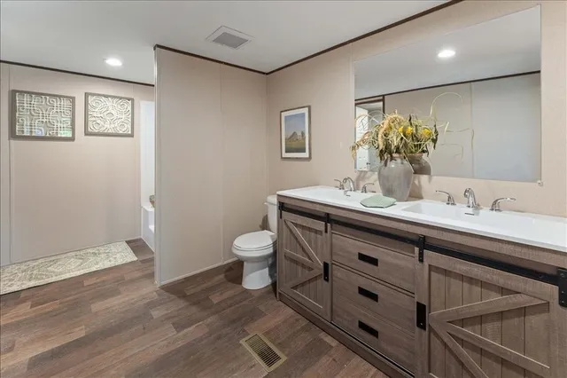 a bathroom with a sink mirror and toilet
