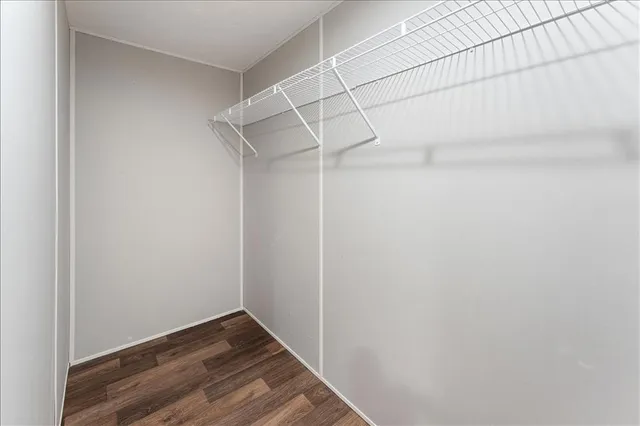 a view of a room with wooden floor