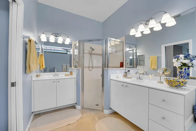a bathroom with a double vanity sink and a mirror