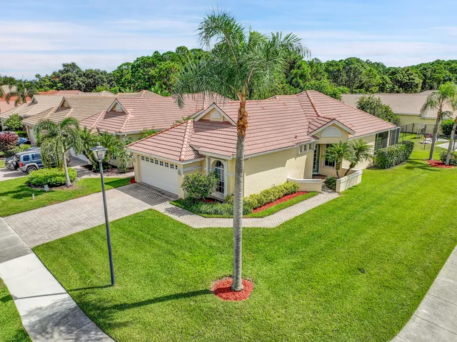 a aerial view of a house with swimming pool and a yard
