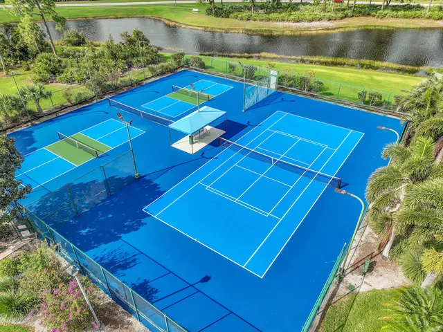 a view of a pool a patio and a lake view