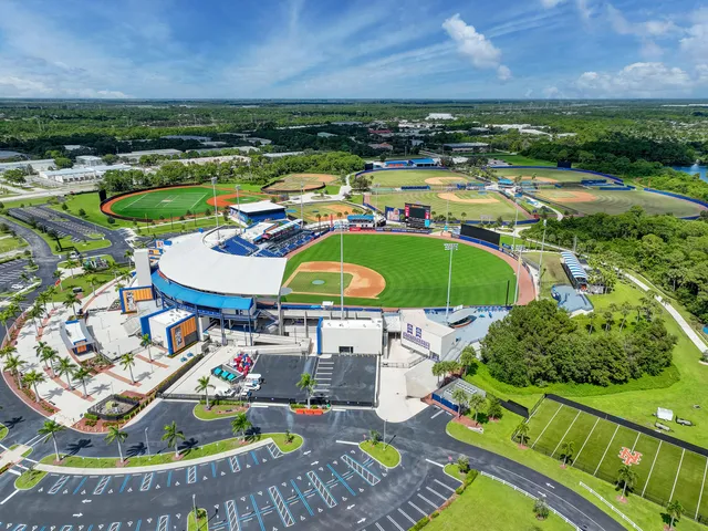 a view of a swimming pool with lawn chairs under an umbrella
