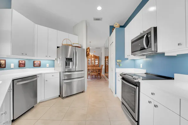 a kitchen with stainless steel appliances granite countertop a refrigerator stove and sink