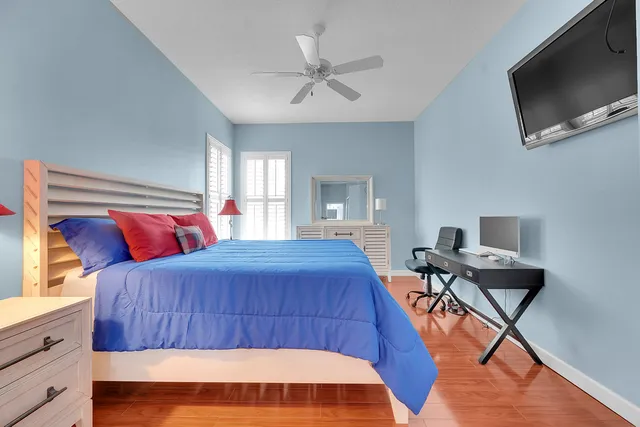 a bedroom with a bed and flat screen tv