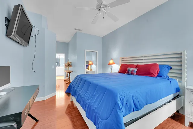 a bedroom with a bed and a flat screen tv