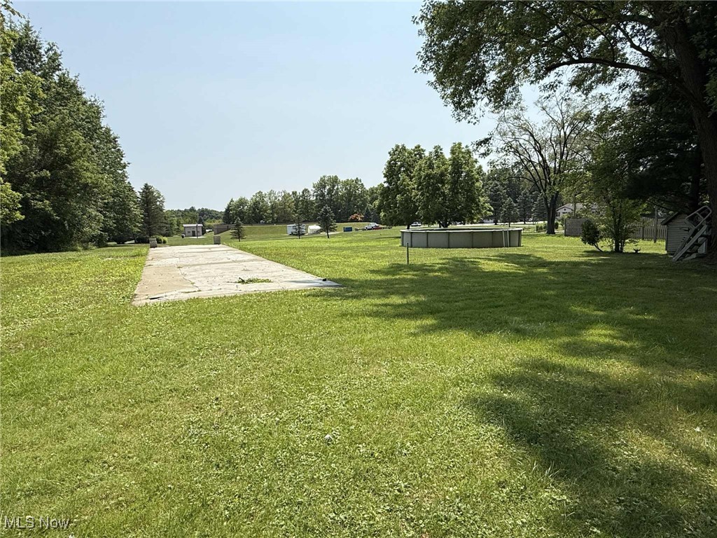 406 Johnson Plank Road Warren, OH 44481 - Photo 15 of 17 Backyard featuring a large concrete slab for a doublewide, garage, workshop etc. and an above ground pool. 1.5 acre lot