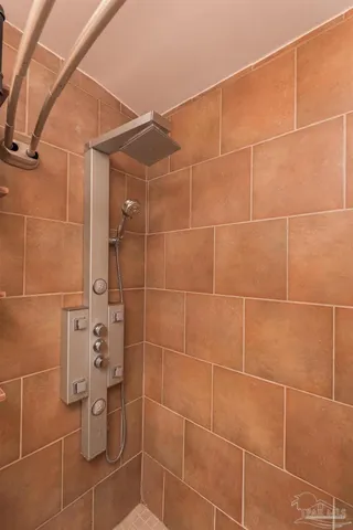 a view of a patio with table and chairs and potted plants with wooden floor and fence
