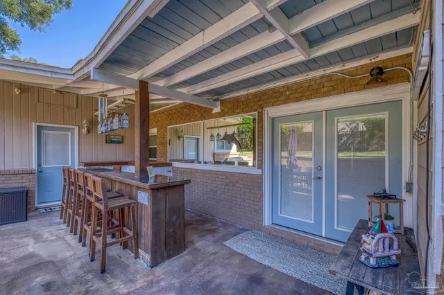a view of a patio with a table and chairs