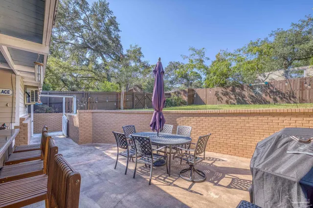 a backyard of a house with yard and outdoor seating