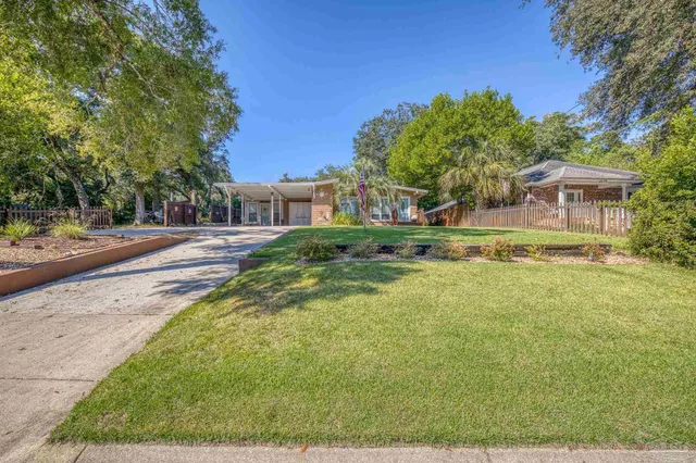 a view of a house with backyard porch and sitting area