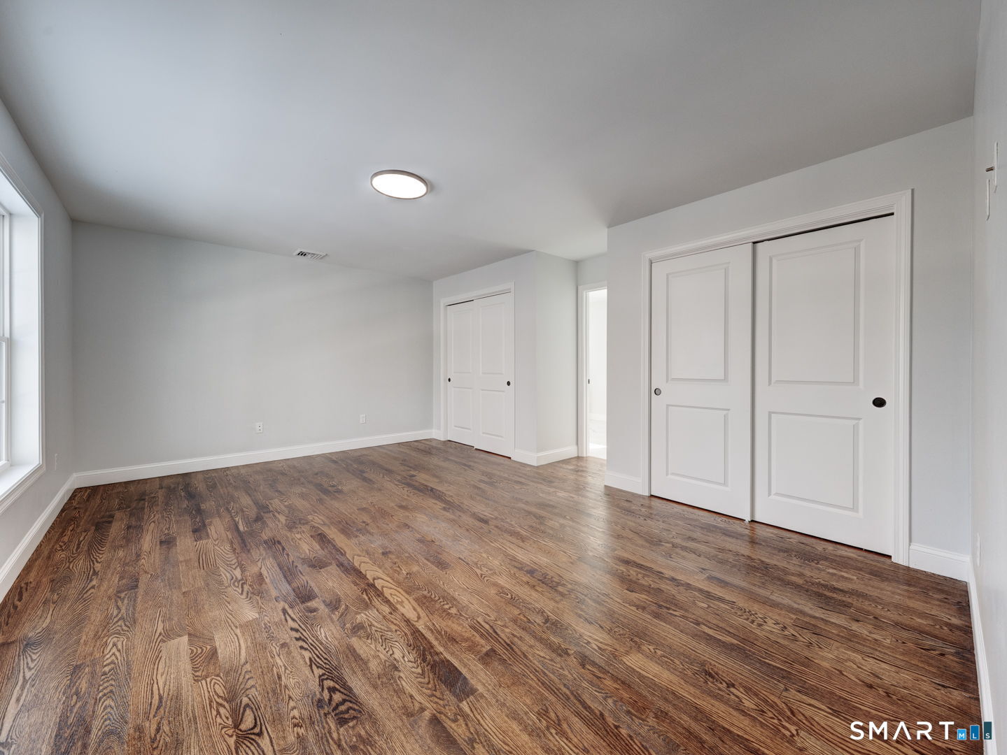 368 Reservoir Road New Britain, CT 06052 - Photo 13 of 32 a view of empty room with wooden floor and fan