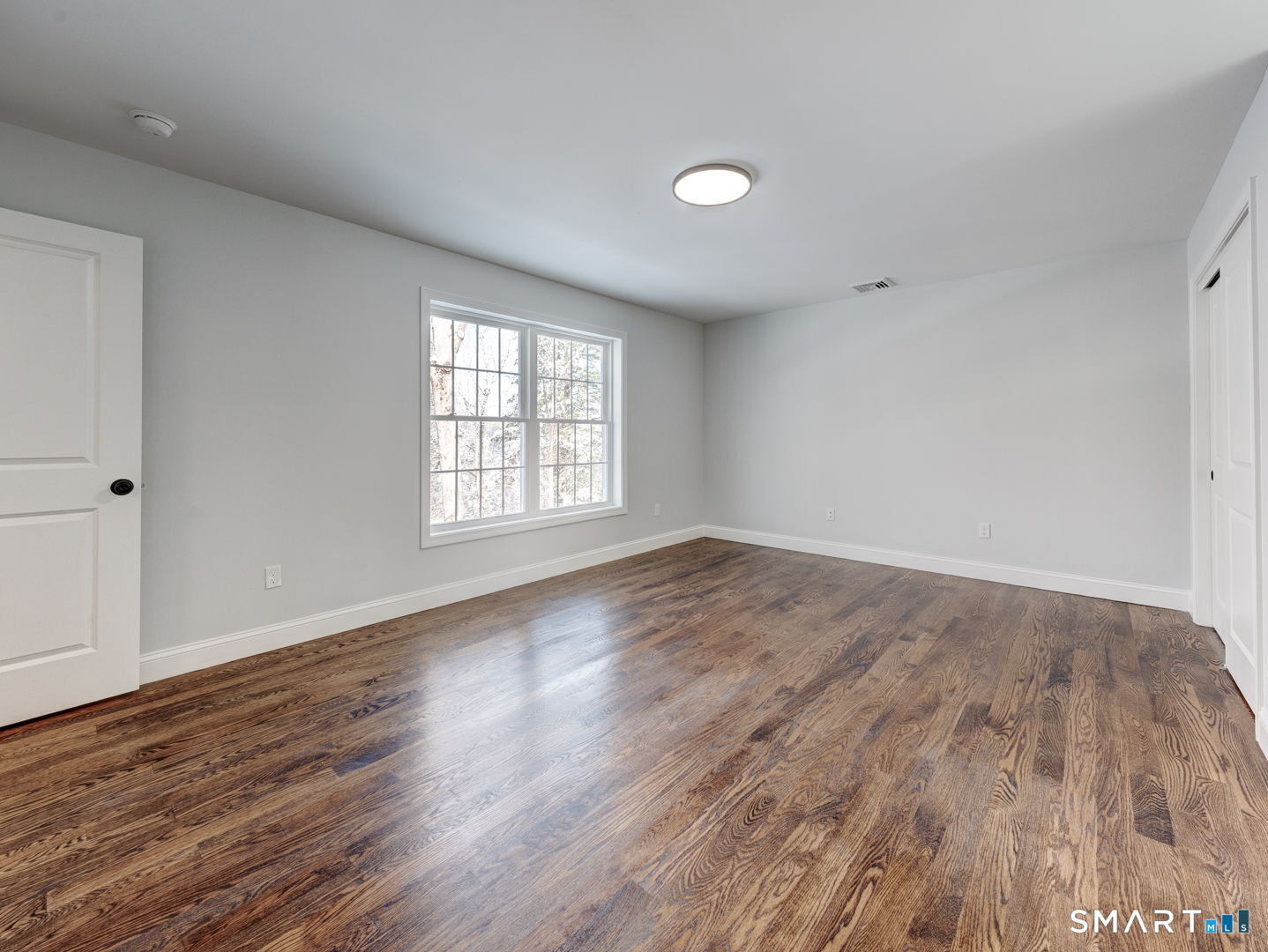 368 Reservoir Road New Britain, CT 06052 - Photo 14 of 32 an empty room with wooden floor and windows