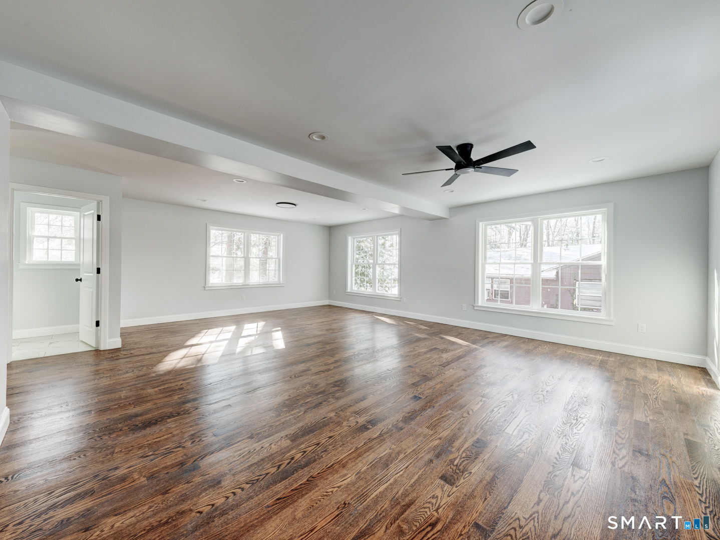 368 Reservoir Road New Britain, CT 06052 - Photo 9 of 32 a view of an empty room with wooden floor and a window