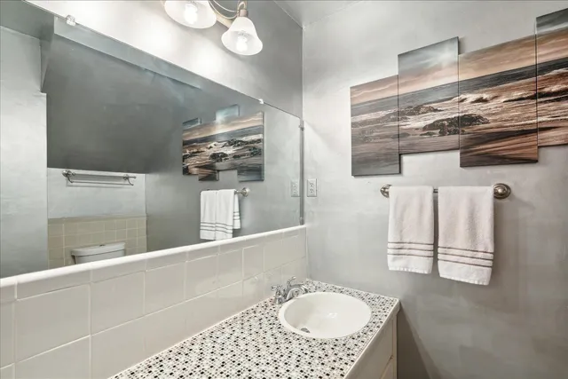 a bathroom with a sink a vanity and mirror