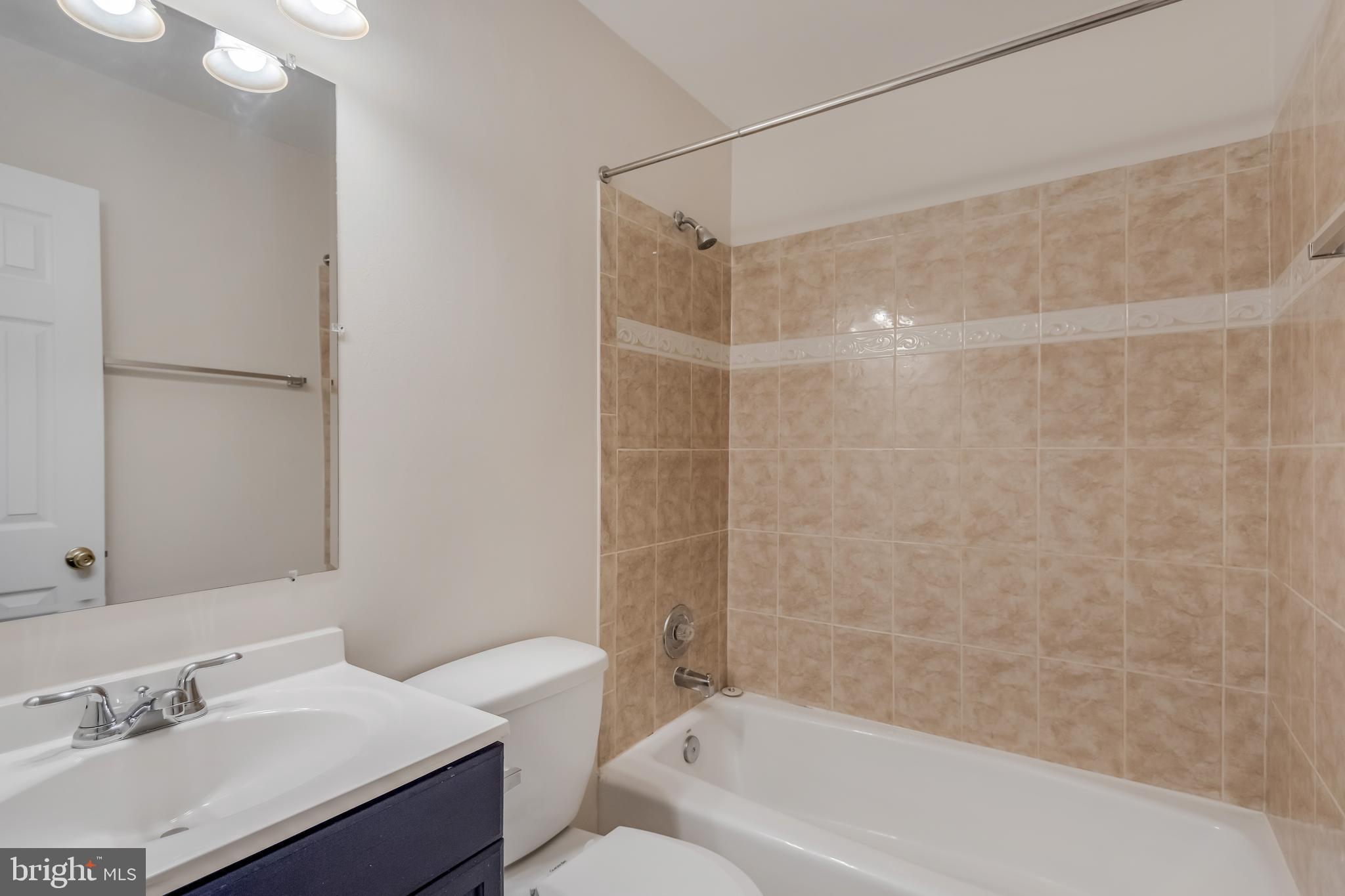11603 Gail Street Silver Spring, MD 20902 - Photo 14 of 19 a bathroom with a sink mirror toilet and bathtub