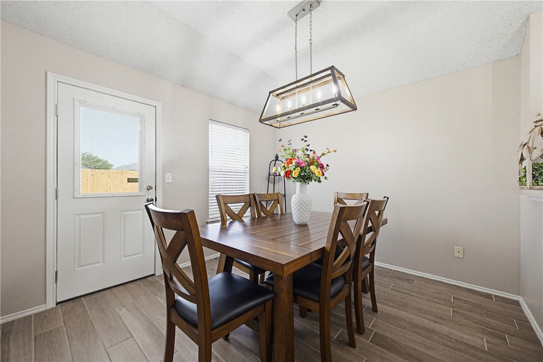 1004 La Mirada Portland, TX 78374 - Photo 11 of 23 a view of a dining room with furniture wooden floor and a chandelier