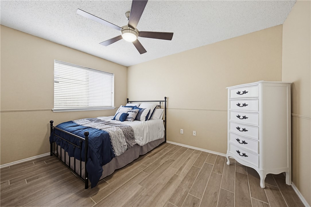 1004 La Mirada Portland, TX 78374 - Photo 14 of 23 a bedroom with a bed and a dresser