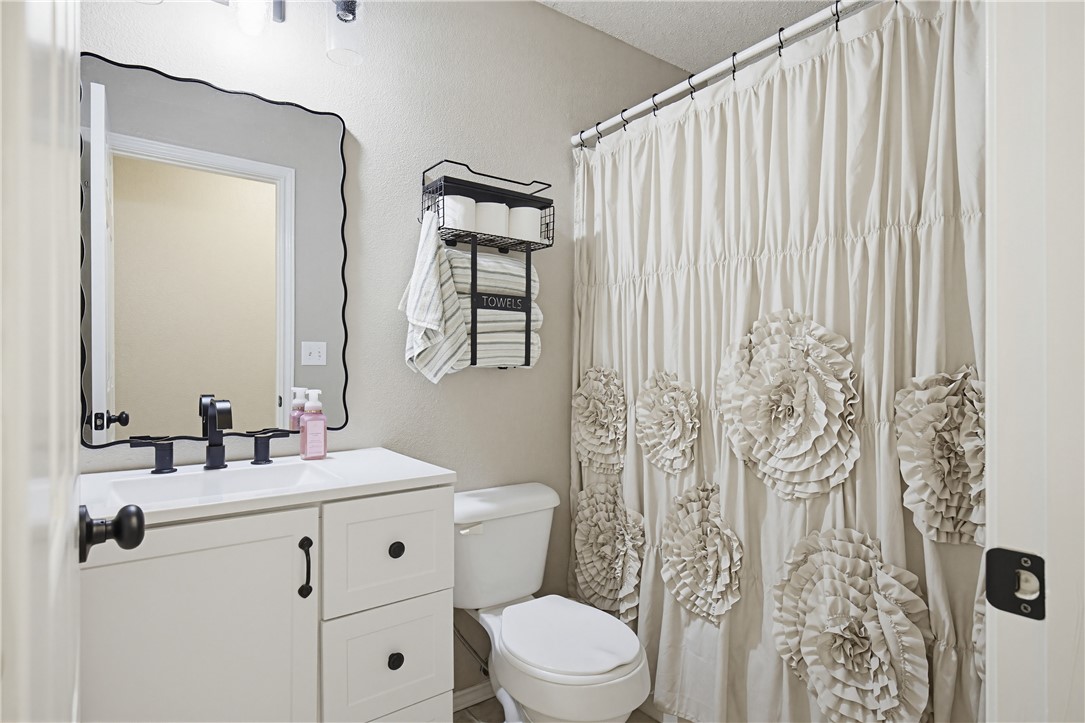 1004 La Mirada Portland, TX 78374 - Photo 16 of 23 a bathroom with a toilet a sink and a mirror