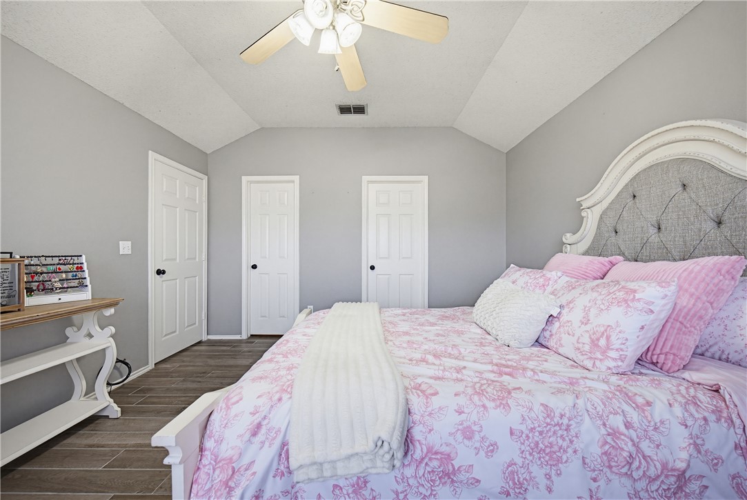 1004 La Mirada Portland, TX 78374 - Photo 20 of 23 a bedroom with a bed and a chandelier