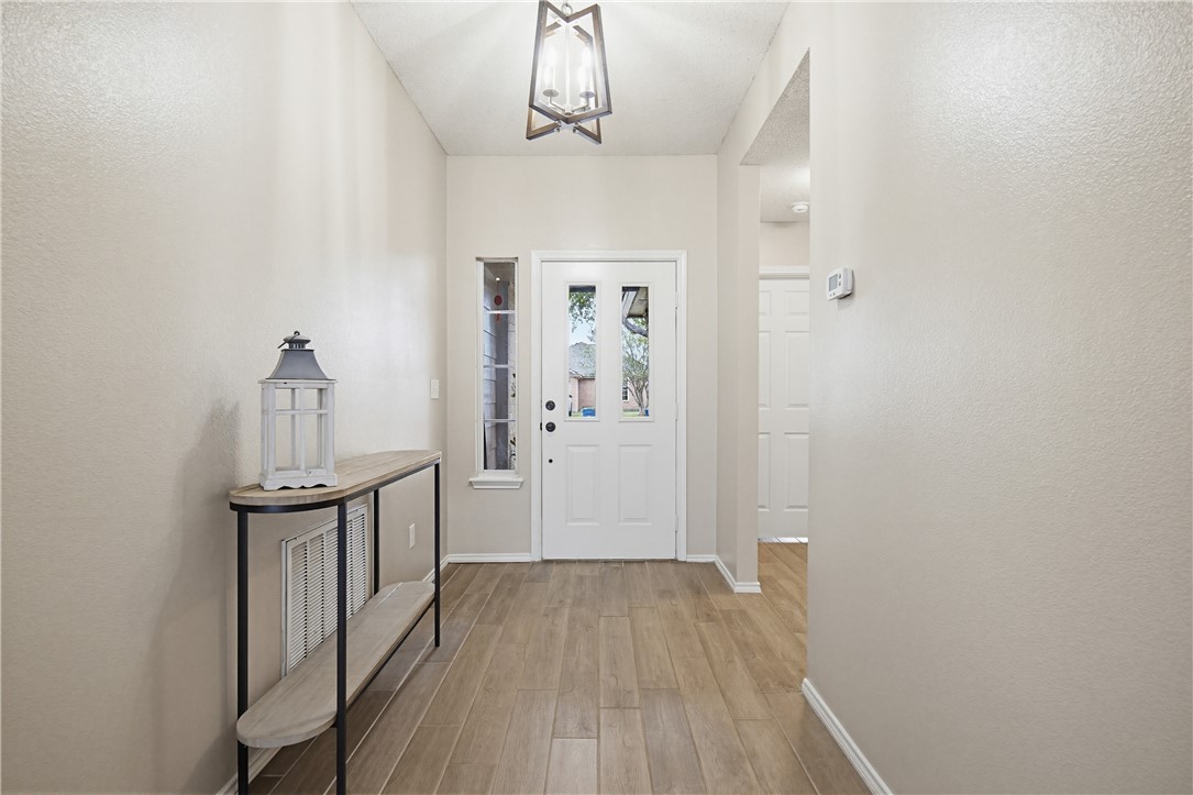 1004 La Mirada Portland, TX 78374 - Photo 5 of 23 a view of a hallway view with wooden floor and staircase