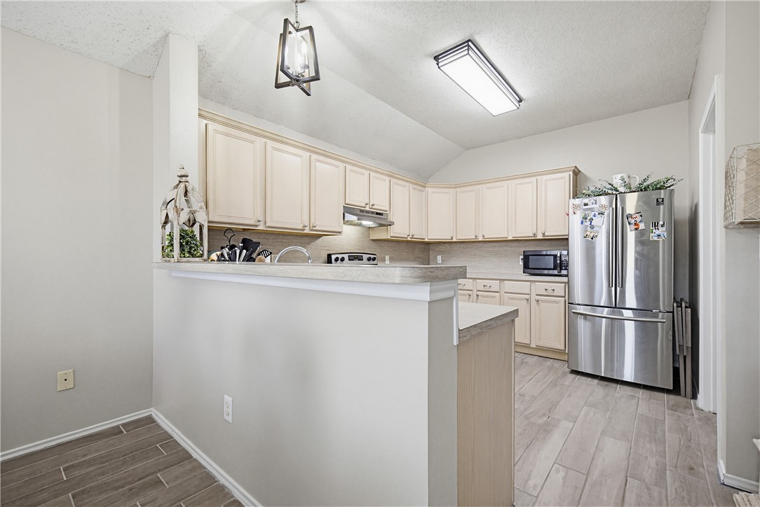 1004 La Mirada Portland, TX 78374 - Photo 8 of 23 a kitchen with a refrigerator a sink and cabinets