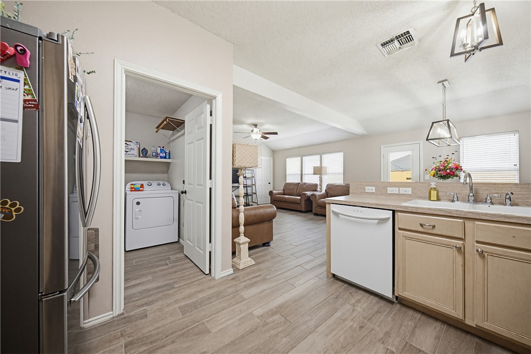 1004 La Mirada Portland, TX 78374 - Photo 9 of 23 a open kitchen with white cabinets and stainless steel appliances