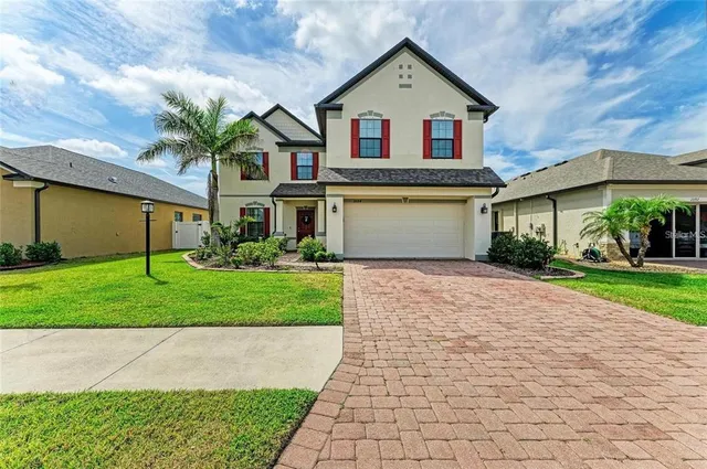 a front view of a house with a yard and garage