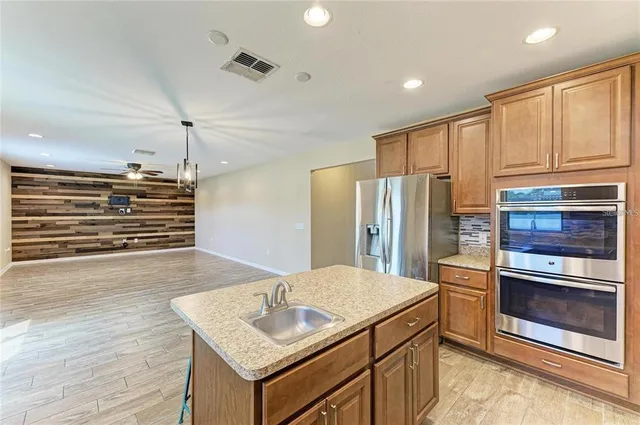 a kitchen with a sink stove and refrigerator
