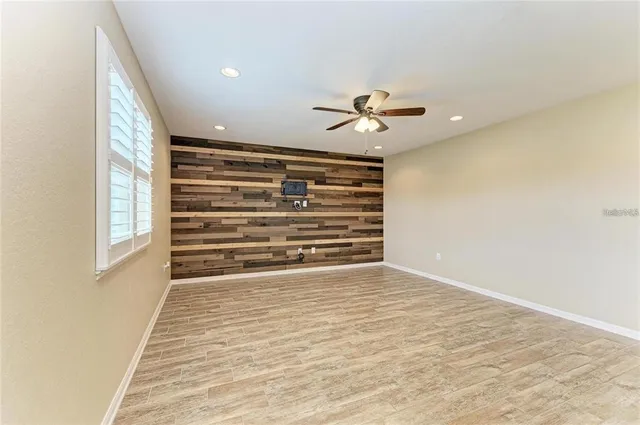 a view of room with a ceiling fan and window