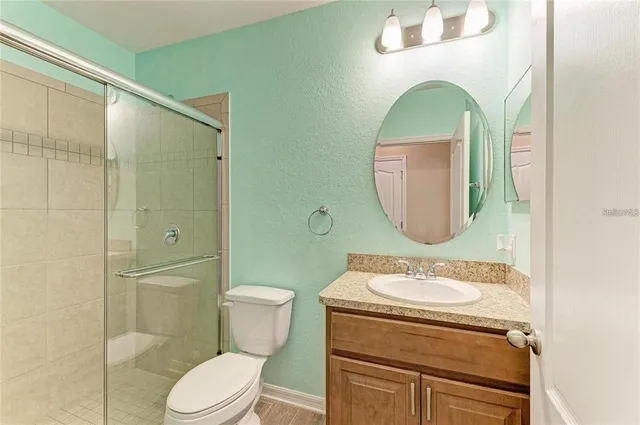 a bathroom with a toilet a sink and mirror