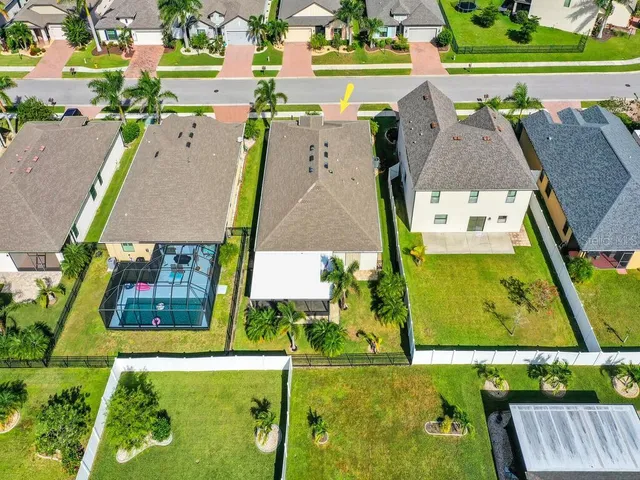 an aerial view of residential houses with outdoor space and street view