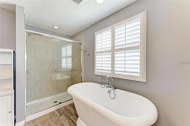 a white bath tub sitting next to a white sink