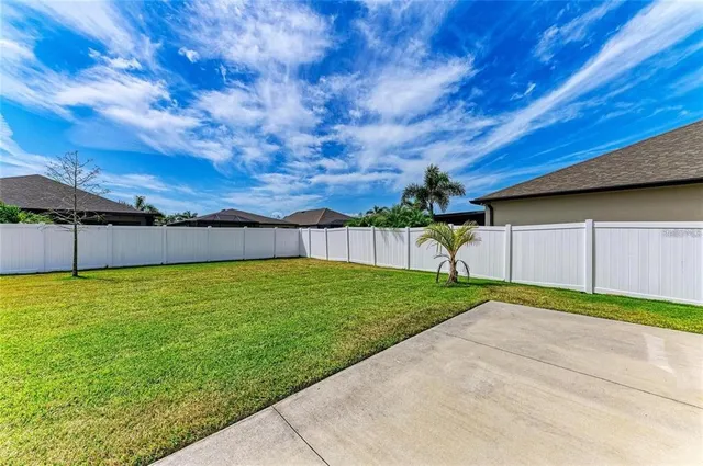 a view of a backyard with a tree