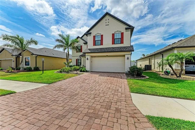a front view of house with yard and green space