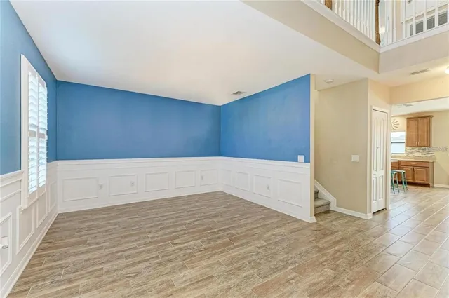 a view of an empty room with wooden floor