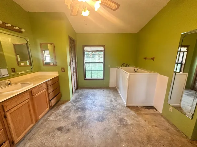 a spacious bathroom with a sink a washer and dryer