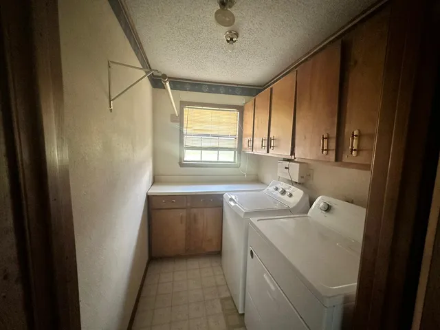 a utility room with closet dryer and washer