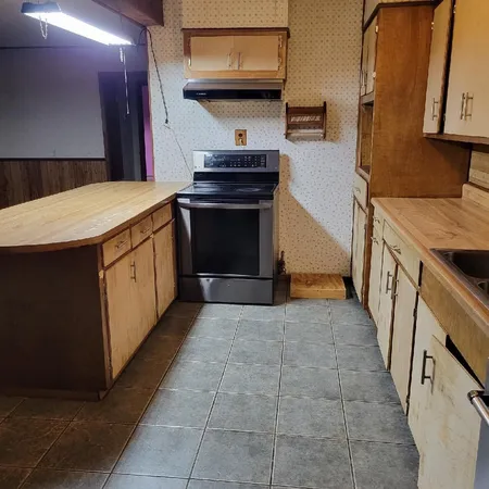 a kitchen with stainless steel appliances a stove and a refrigerator