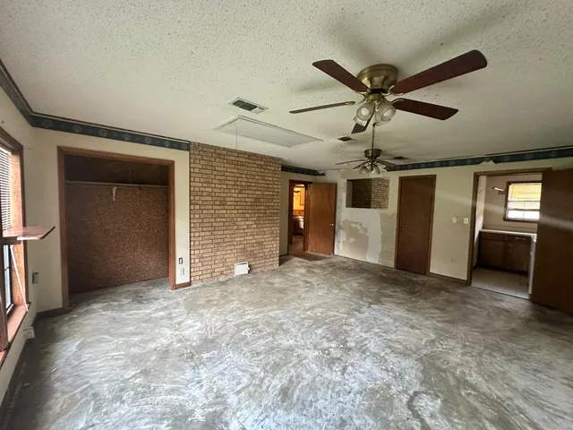 a view of a livingroom with a ceiling fan and a window