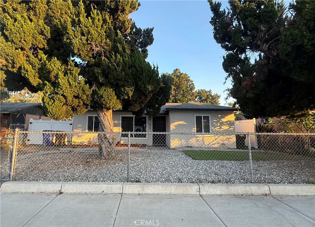 a view of a house with a backyard and a tree