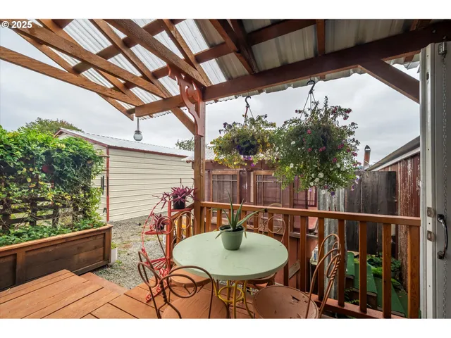 a balcony with table and chairs