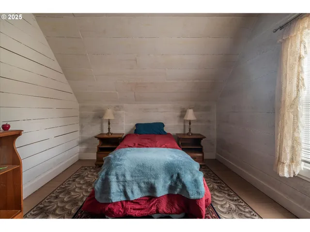 a view of a wooden floor and a table in a window