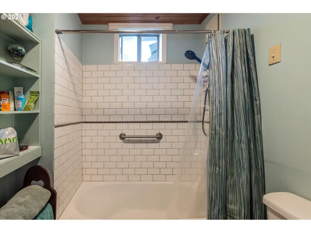 a bathroom with a shower and a sink